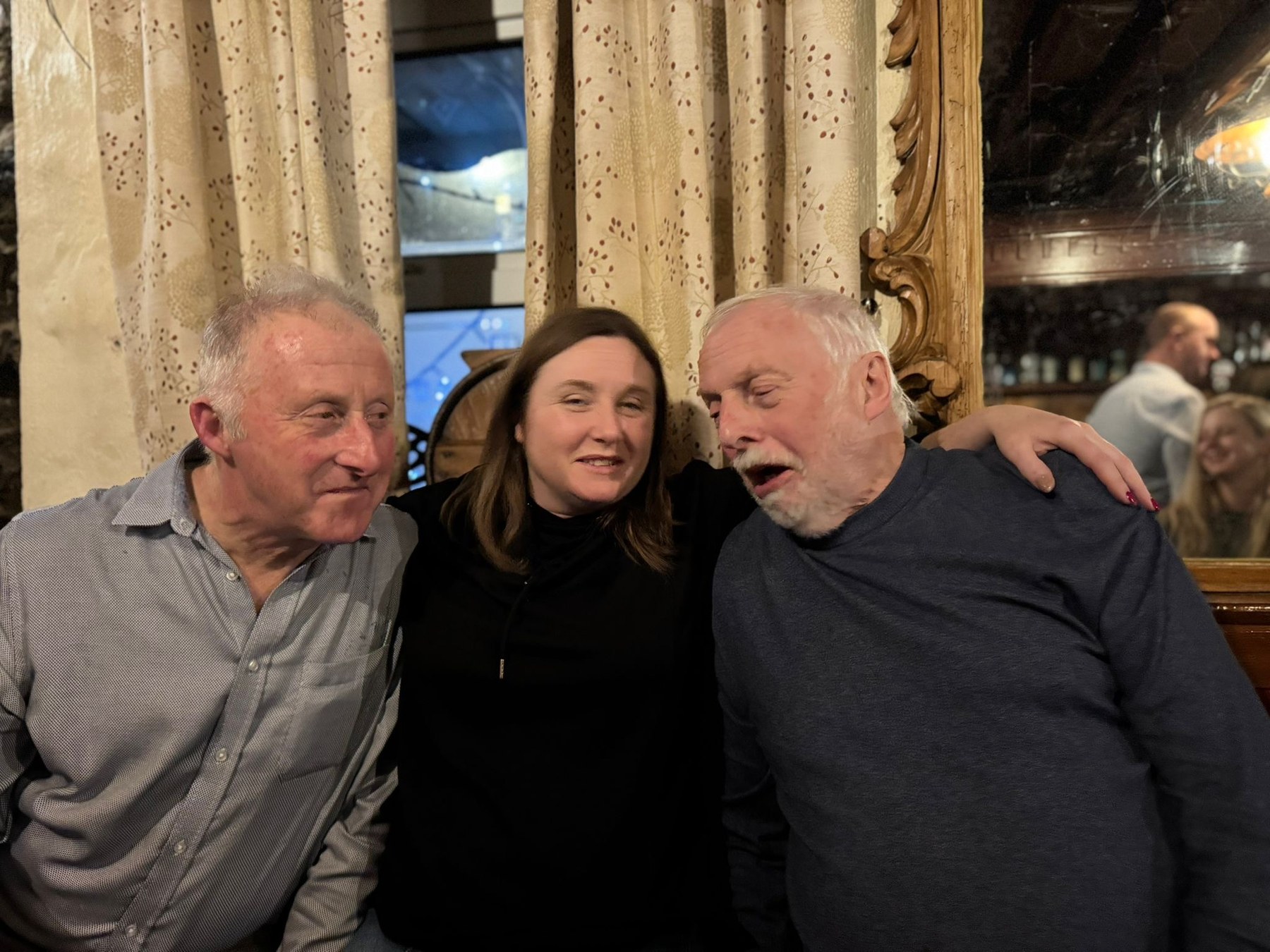 Family members laughing together at a pub table