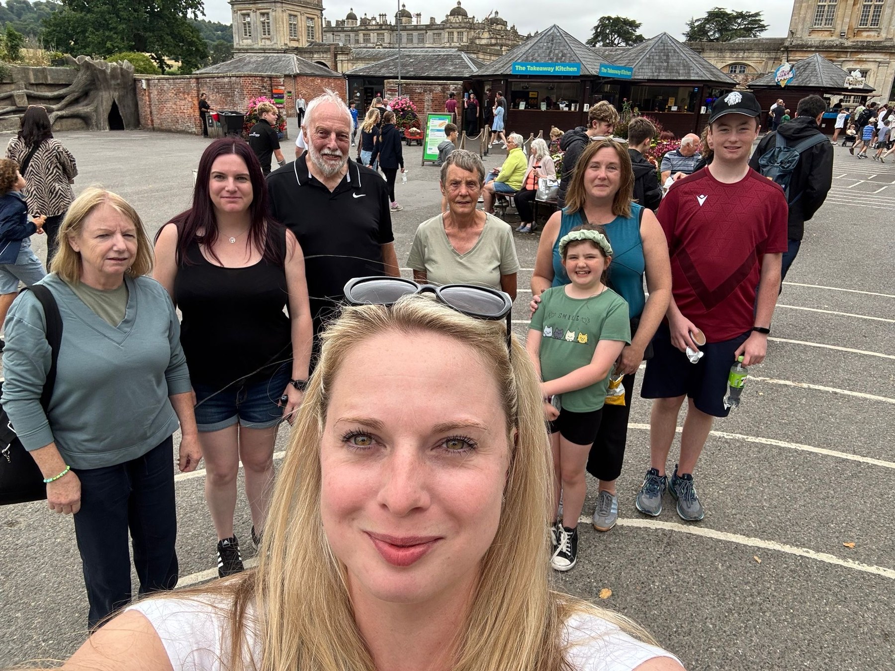 Family group smiling outdoors on a day out