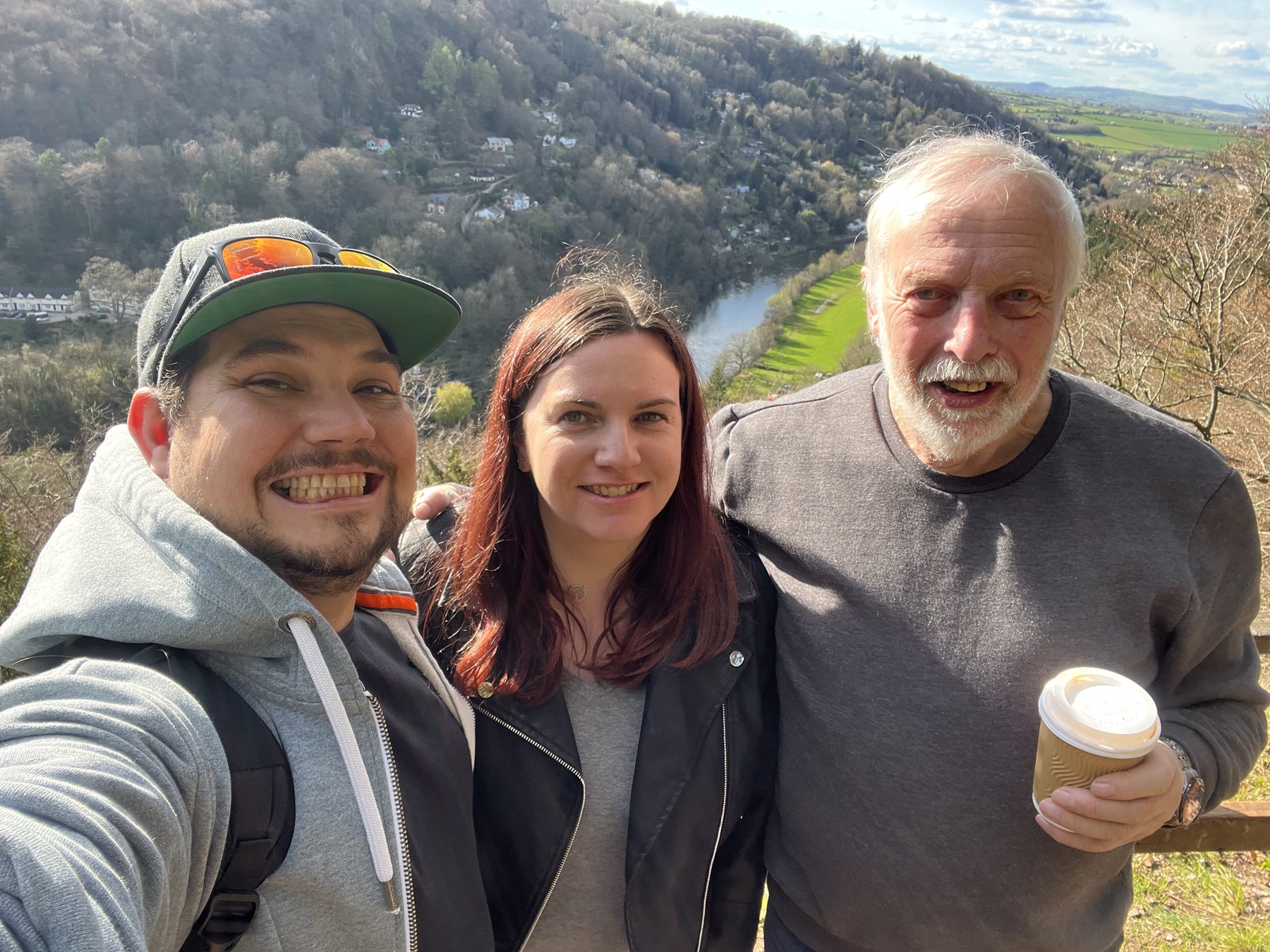 Family selfie outdoors with a countryside view